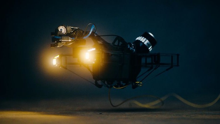 A physical tether carries both power and data, forming a fully wired path between drone and operator.