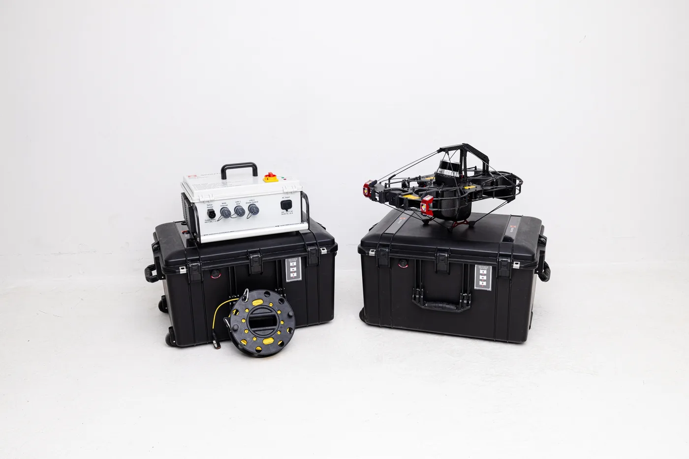 The complete Scout 137 Gen 2 kit — drone, ground station, tether spool and the two transport cases