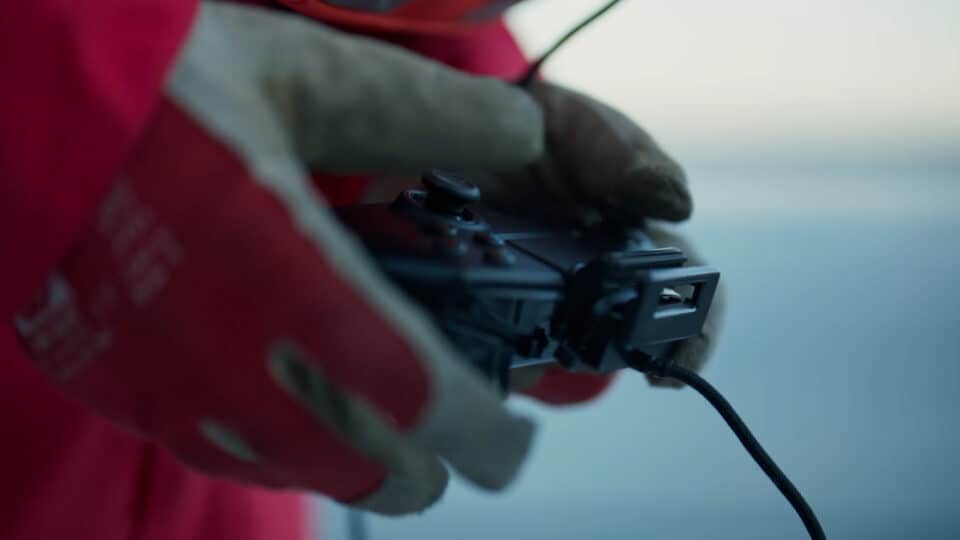 Gloved hands with drone controller