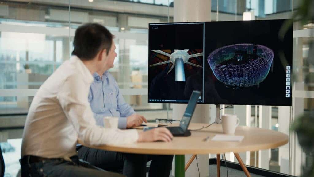 Man reviewing inspection data on large LED screen